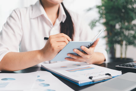 Business woman analyze calculate company financial, tax results office accounting statistics analytical research. calculating business balance prepare tax reduction. Tax deduction planning concept.の写真素材