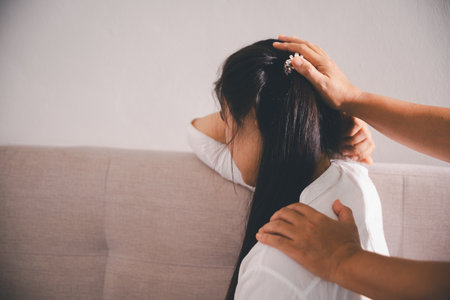 Moment of deep grief, sorrow and anxiety, lonely person overwhelmed by despair feels spark of hope when helping hand reaches out with genuine emotion to ease their problem.の写真素材