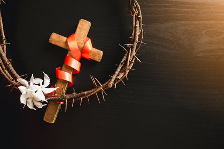 Crown of thorns, wooden cross, iron nail placed on Holy Bible, symbolizing Christian faith,...