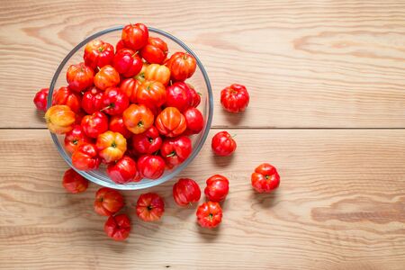 tasty sweet and fresh cherries in a glass bowl on wood tableの写真素材