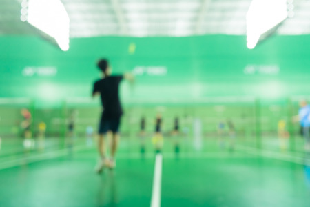 defocused of indoor badminton courts with players are playing at nightの写真素材