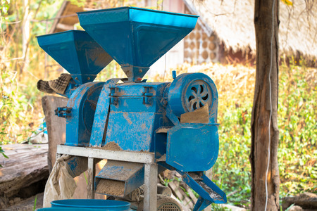 small rice mill machine after work in the farm, very useful rice mill machine for home use or small business.の写真素材