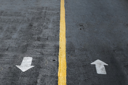 two arrow of a different directions on the concrete way. outdoor directions to make a choice.の写真素材