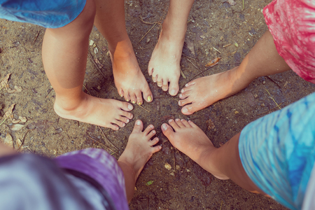 Girls group shown the unity and enjoy the rainforset trip with funny poses and barefoot. vintage color filter added.の写真素材