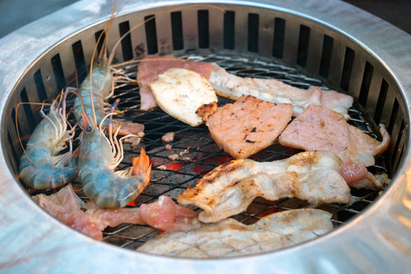 simple korean grill style restaurant with many kind of food, shrimp, pork, ham の写真素材