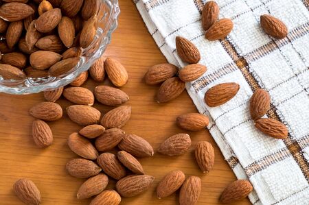 Almonds seed nut on the wooden table, healthy almond nuts with nature tasty.の写真素材