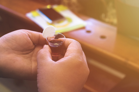 Girl holding bread and wine in a Holy communion.の写真素材