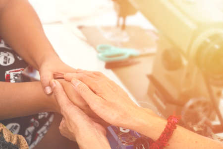 Two women praying together and encourage each other. color filter added.の写真素材
