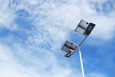 Solar cells LED light in blue sky with clouds. Eco and Clean Power concept.
