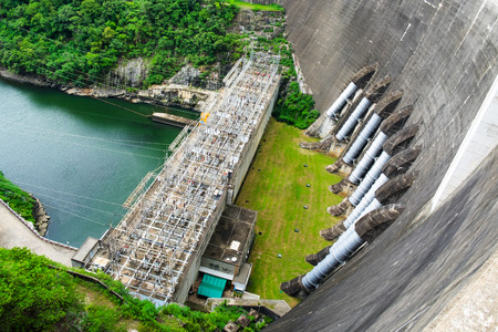 Big Concrete Dam over the river produce an electric power.の写真素材