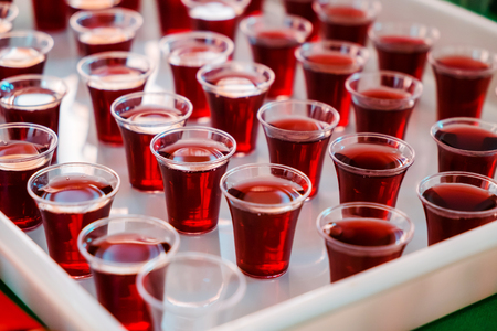 Grape juice in the Plastic cups for Holy Communion in the Church.の写真素材