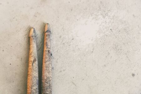 Old and Hard work Drumsticks Lay on a Snare Drum Skin. Represent of Hard Practice musician.の写真素材