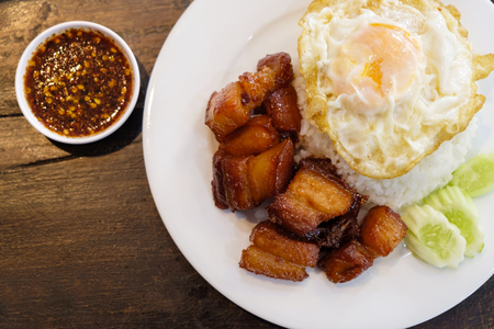 Sweet Fried Streaky Pork and Spicy Fish Sauce with Rice on the Wood Table.の写真素材