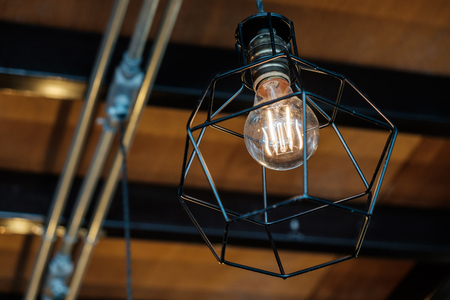Vintage Retro Light Bulb hanging Down from the Ceiling.