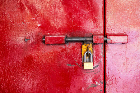 Stainless Steel Safety Padlock Security on Vintage Retro Red Metal Door.の写真素材