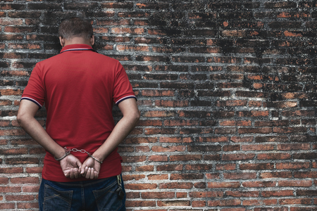 Man under Arrest, Criminal Scence of Man get Caught with Handcuffed by the Policeman.の写真素材