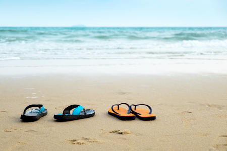 Two Pairs of Lover Sandal on the Beach, Romantic Scence in the Vacation Beach Trip Travel.の写真素材