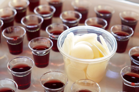 Many Cups of Wine and Bread set for a Holy Communion.の写真素材
