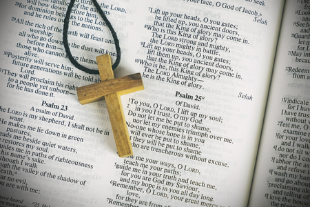 Wood Cross Sign Symbol and Praying to God with a Bible in the Morning Devotion.