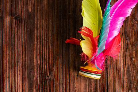 Close-up Shuttle Cock Kicking, Colorful Feather Chinese Jianzi Foot Sports, Hacky Sack Foot Feather on Wood Background.の写真素材