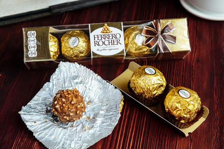 2019-02-05 Ferrero Rocher, Small Size Luxury Chocolate Snack Packs on the Wood Table for Relax Time, Bangkok Thailand.のeditorial素材