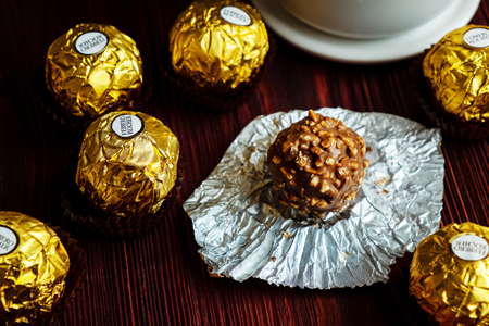 2019-02-05 Ferrero Rocher, Small Size Luxury Chocolate Snack Packs on the Wood Table for Relax Time, Bangkok Thailand.のeditorial素材