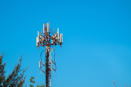 Cell Site Post in the Clear Blue Sky with Clouds. Telecommunication Technology Pillar.