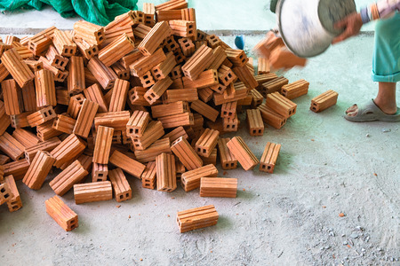 Asian Worker Prepared Red Brick for Building Wall in the Work Site.