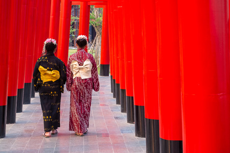 Couple Kimono Girl Walking Together Along Red Gate Temple Walk Path.の写真素材