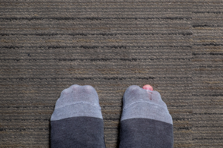 Old Sock Tear Show Foot Finger on the Floor.