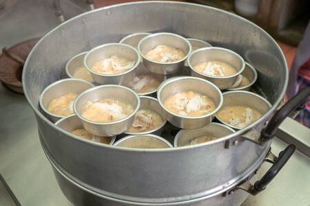 Banana Tart and Coconut Meat Topping in Steamed Pot, Traditional Thailand Cuisine Dessert.の写真素材