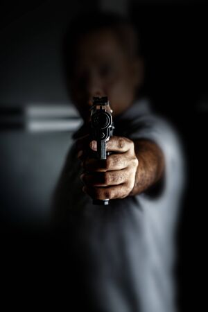 Man Carrying a Toy Gun to Rob the Money. Robber in the Shadow with Toy Gun Rob Money. Concept...