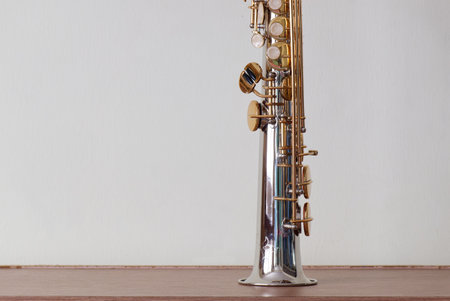 Golden Key Silver Plate Soprano Saxophone, Woodwind Instrumental Equipment on White Wall Background.