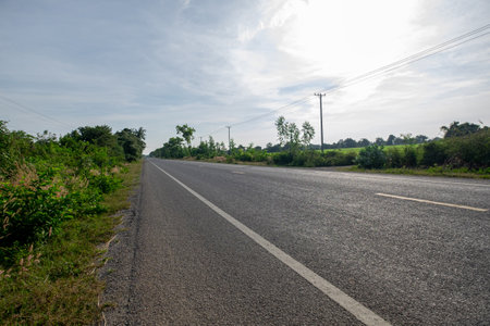 An Empty Asphalt Road in a Remote Rural Area, Surrounded by Simple, Peaceful, and Beautiful Nature.
