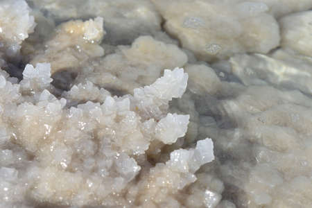 Dead Sea coastline with white salt beach in Ein Bokek, Israel. Famous Middle East health landmark....