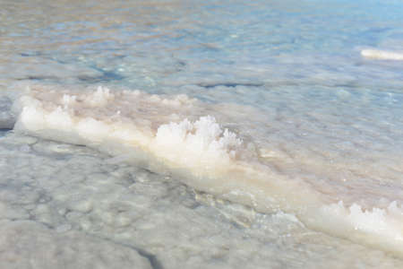 Dead Sea coastline with white salt beach in Ein Bokek, Israel. Famous Middle East health landmark....