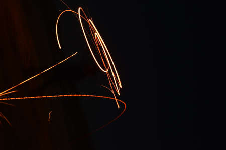 Iron wool circle drawing light fireworks. Burning Steel Wool spinning, Trajectories of burning...