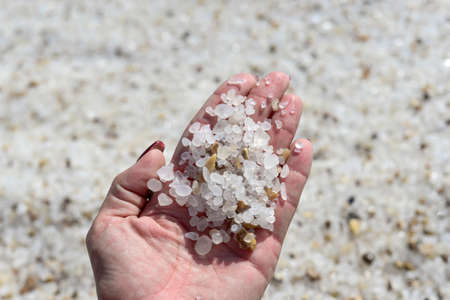 Sea salt crystals in women hand natural mineral formation at the Dead Sea. holding sea salt crystals...