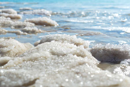 Close-up of salt crystals on the seashore. Natural background