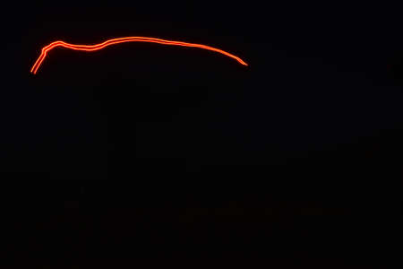 Red neon light in the dark. Abstract background for your design.の写真素材