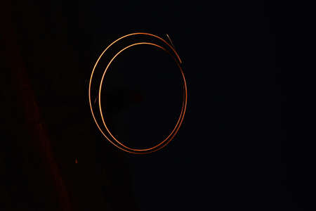 Light painting in the shape of a circle on a black background.の写真素材