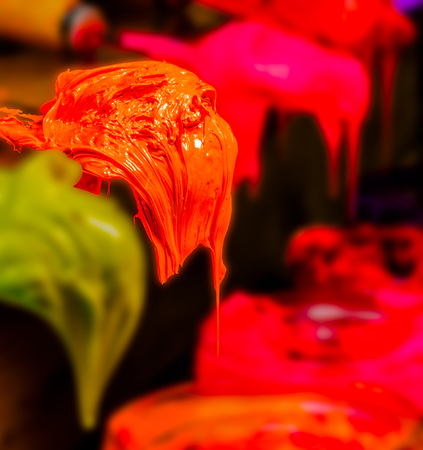 orange color of ink for print tee shirt is dripping from trowel. picture in square with copy space for add textの写真素材
