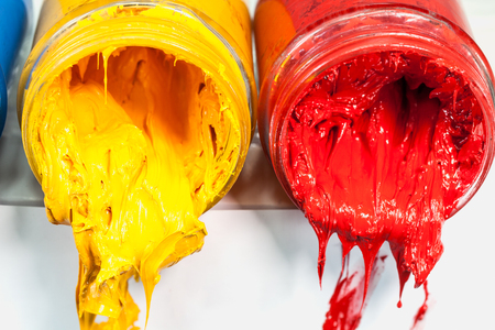 yellow blue and red colors of Plastisol ink on white table. Plastisol ink for print tee shirt and any fabric useful in tee shirt factory. yellow blue and red colors are primary color.の写真素材