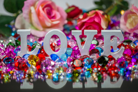 The word love is located on the area of colorful diamonds and roses, the word love is love for Valentine's Day.の写真素材