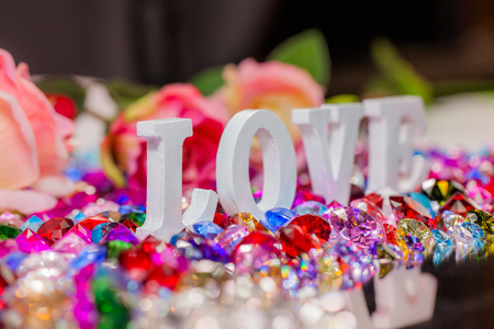 The word love is located on the area of colorful diamonds and roses, the word love is love for Valentine's Day.の写真素材