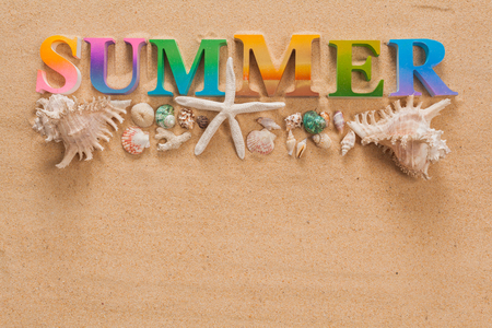 summer written in colorful letters decorate with starfish on the beach with copy spaceの写真素材