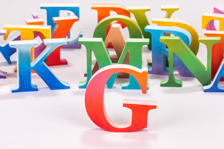 colorful uppercase english letters on white background.