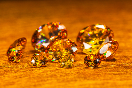 yellow diamonds in different  size on golden backgroundの写真素材