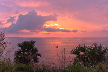 panorama sunset at Laem Promthep Cape. The landmark and popular viewpoint of Phuket Thailand. in every day a lot of tourists come here to watching sunset.の写真素材