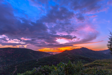 light through the cloud above mountain at sunsetの写真素材